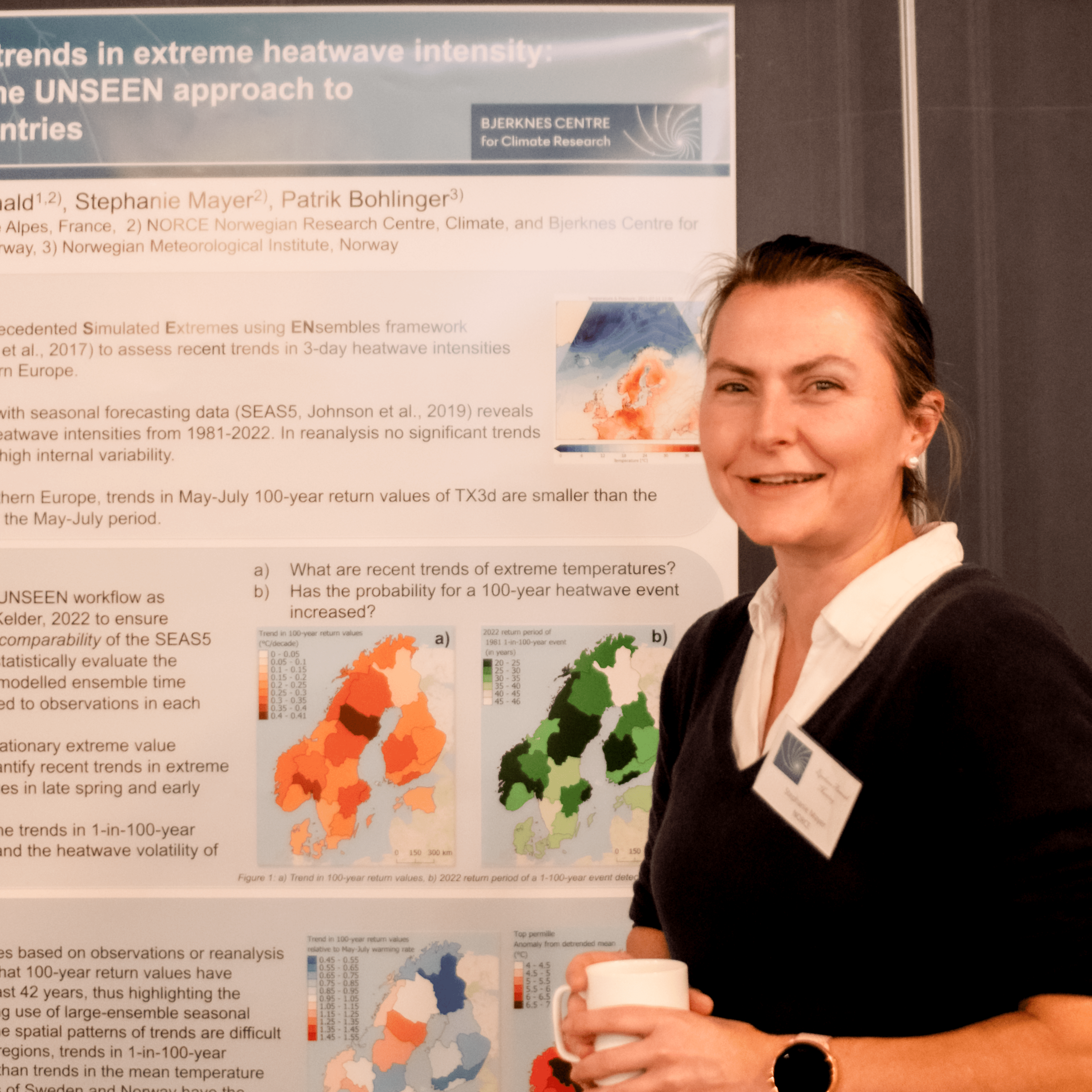 Stephanie Meyer, researcher with NORCE and Bjerknes Center, standing in front of a poster on Extreme Heatwave Intensity.
