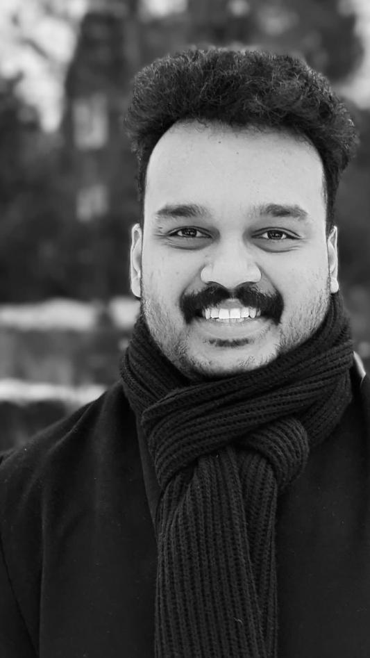 Black and white portrait photo of Ashbin Jaison. 